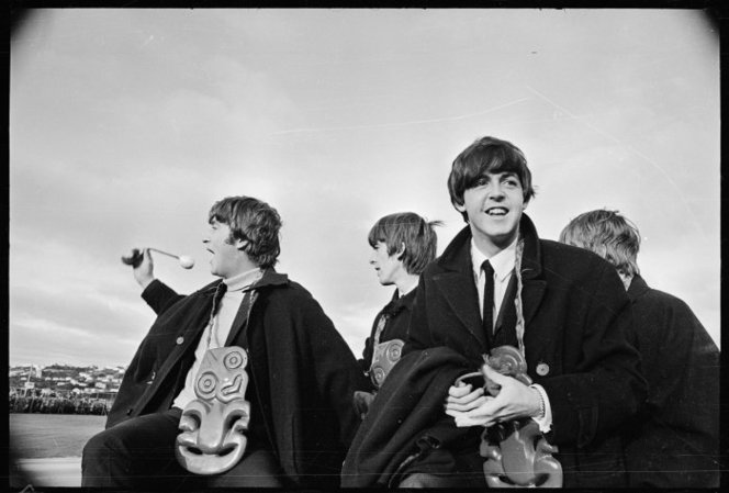 The Beatles at Wellington Airport, June 1964. They are wearing tikis (good-luck charms) around their necks. John is waving a poi, used by Maori female dancers.